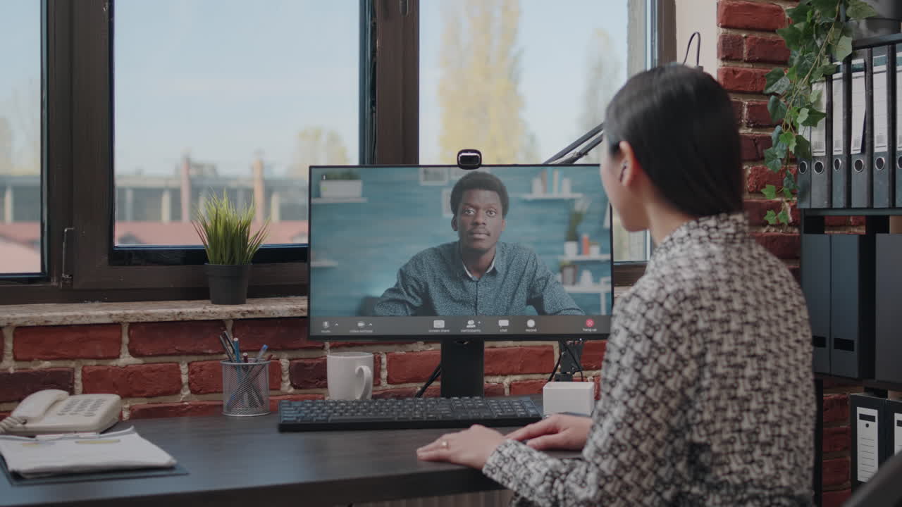 Business woman using video call meeting to talk to colleague