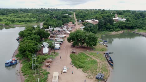 aerial dolly in shot of small fishing village by lake in ghana west africa