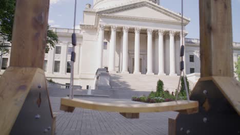 Almost-Heaven-wooden-swing-in-front-of-West-Virginia-state-capitol-building-in-Charleston-West-Virginia-with-video-tilting-up