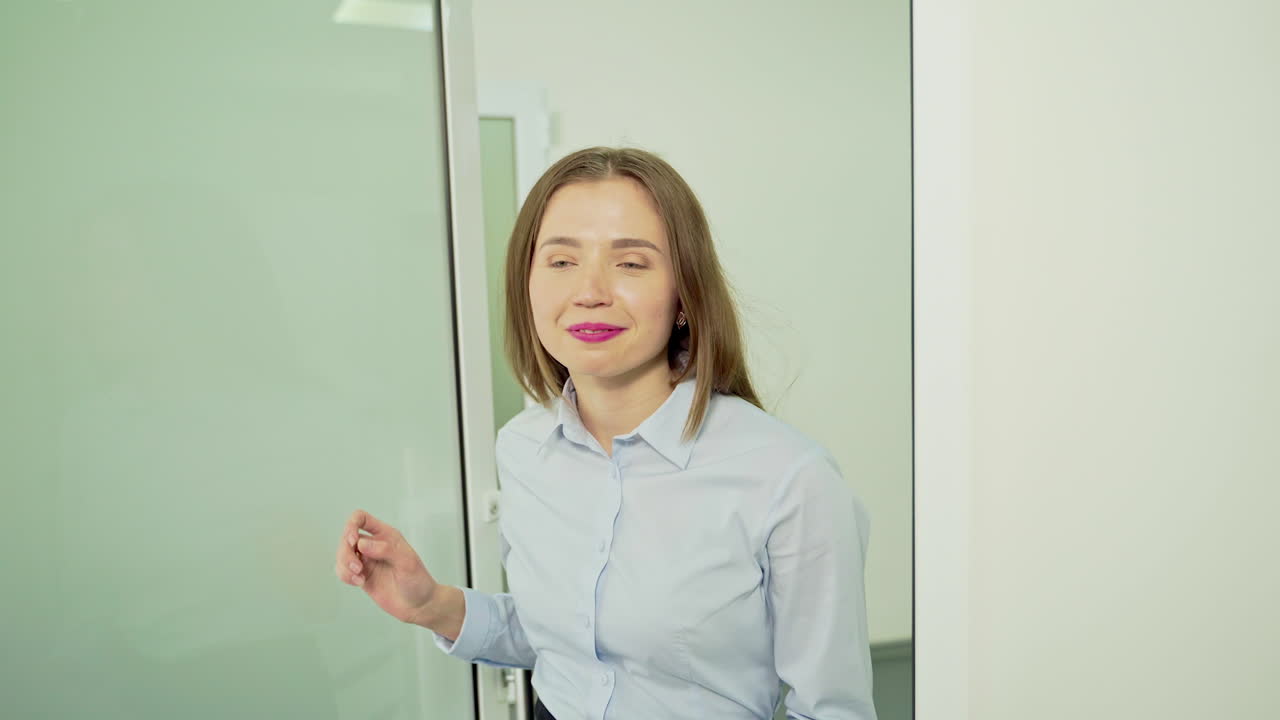 Smiling woman in the hospital. Beautiful girl at the receptionist's in modern clinic. Patient comes into the doctor's cabinet. Healthcare concept.