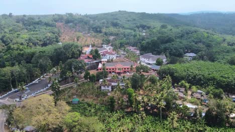 aerial view of a church and village in the hills of kerala, india