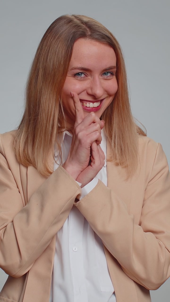 Sneaky businesswoman conspiring scheming thinking tricky plan with cunning expression joke prank