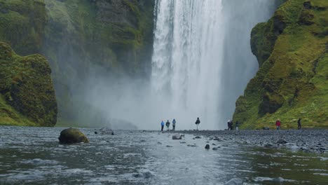 most famous skogafoss waterfall with river reflection, iceland