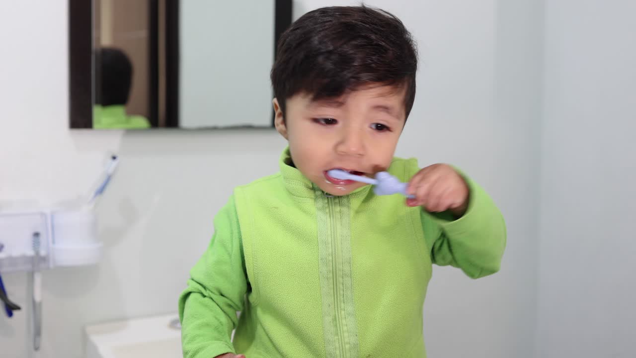 Mexican baby learning to brush his teeth