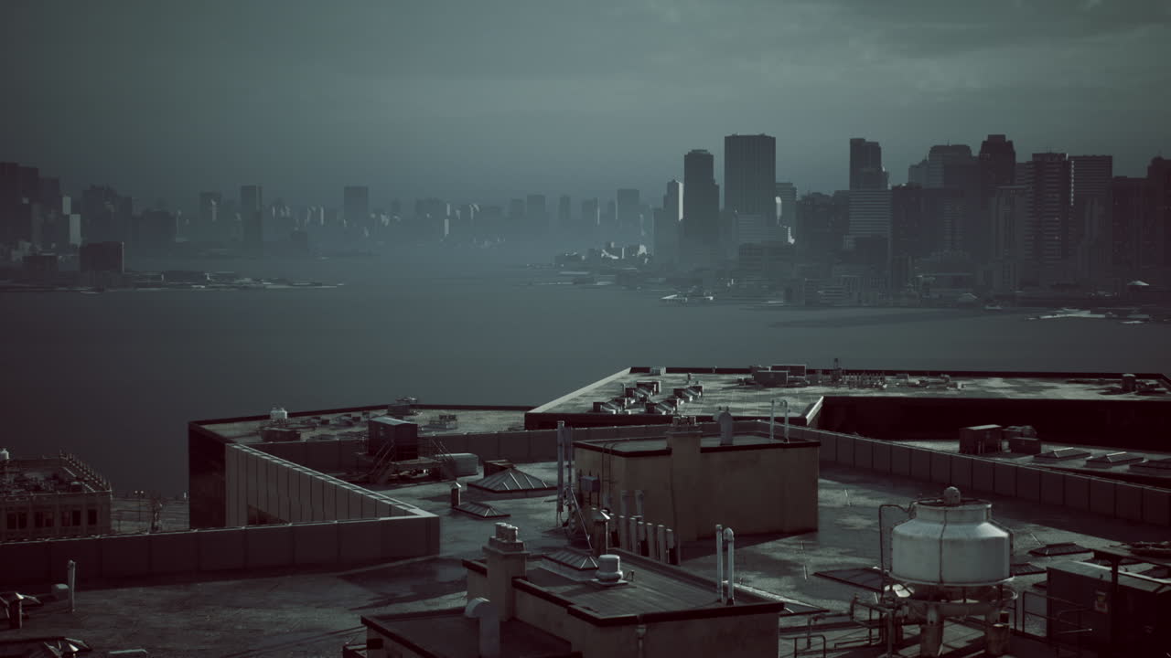 Dark urban skyline viewed from a rooftop with water in the foreground