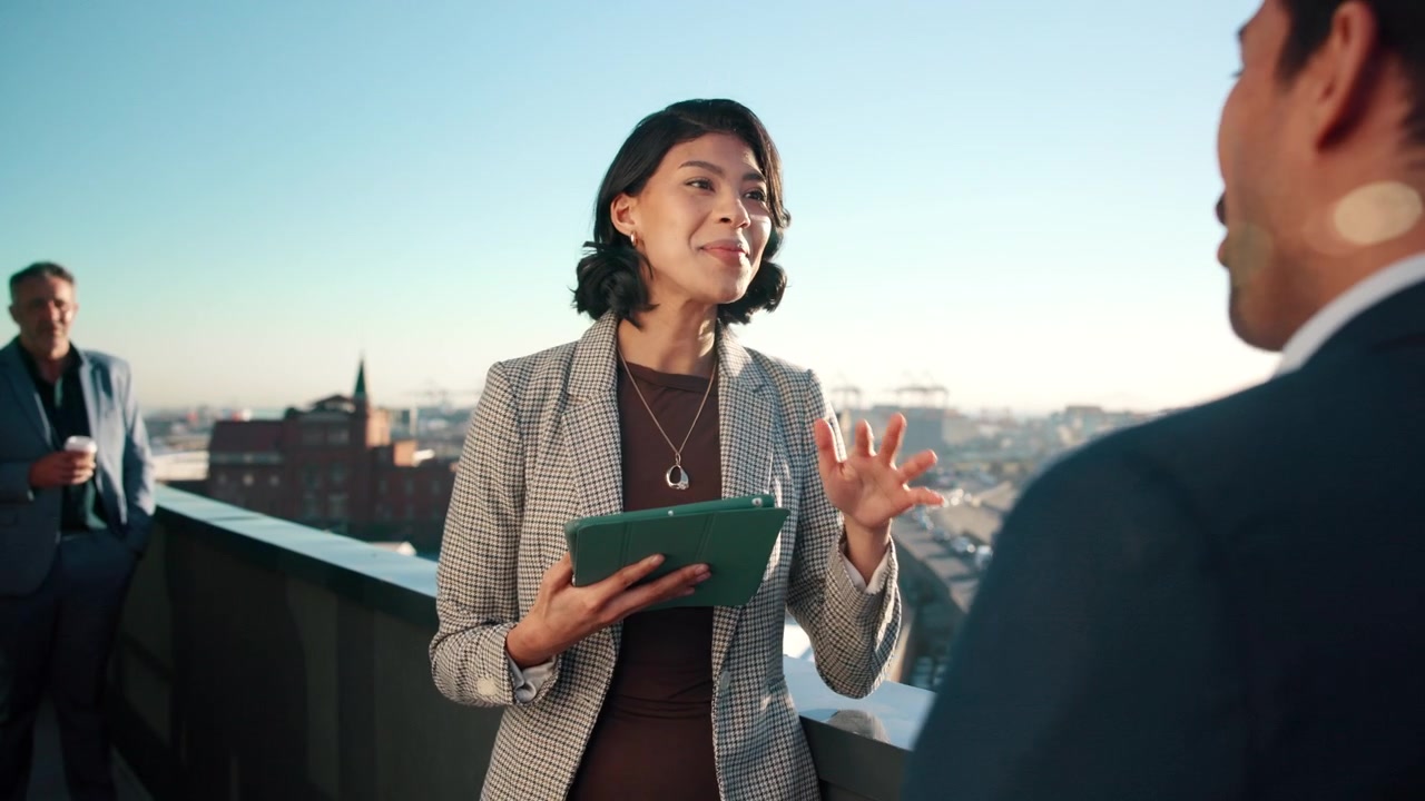 Businesswoman Discussing Strategy with Colleague on Rooftop Terrace