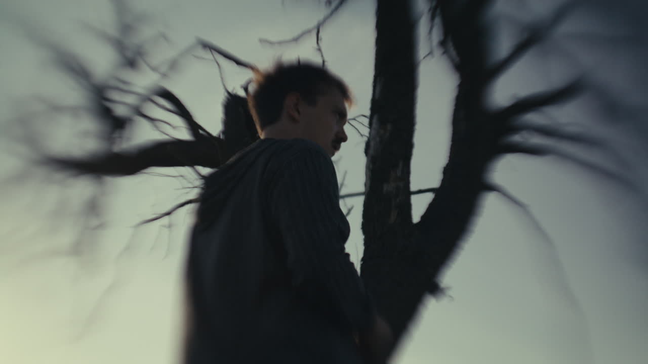 Blurred Profile of a Man Against a Tree and Sky