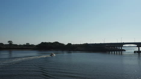 slow-dramatic-drone-take-off---flight-over-a-small-boat-in-Shell-Bank-Creek-in-Brooklyn,-NY