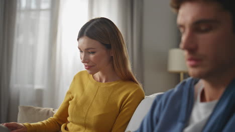 closeup man fingers working laptop at apartment. smiling woman looking husband