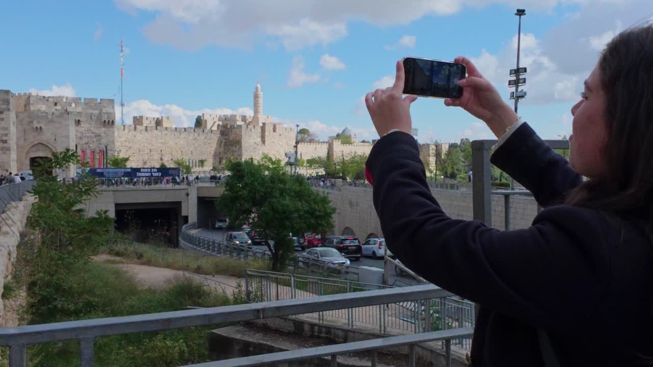 Tourist taking pictures of Jerusalem old city walls