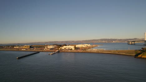 Drone-jib-down-to-Treasure-Island-in-San-Francisco-bay-at-sunset