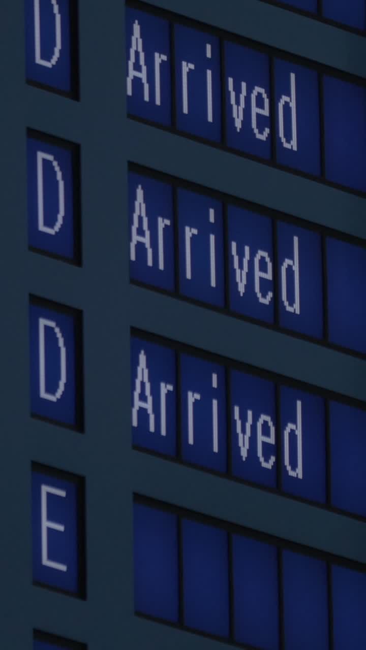 Airport Arrival Board Showing 'Arrived' in Multiple Languages