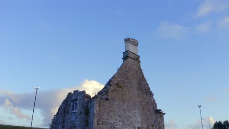 terryland castle walls on river corrib, galway ireland exposed against bright blue sky