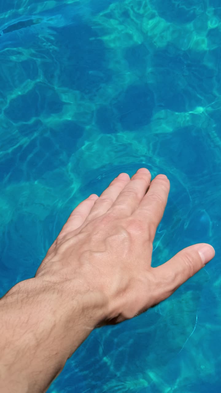 Hand touching water