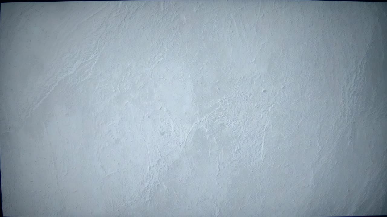 Recording camera capturing gray plaster wall in room monitoring darkening cracks and thin borders
