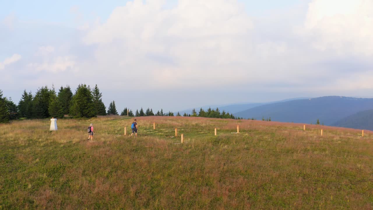 Hikers discover beauty of nature on mountain of Slovenia. Aerial forward