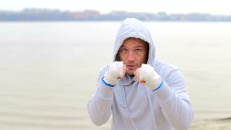 boxer boxing into camera lens slow motion boxer fight with shadow in nature boxing workout