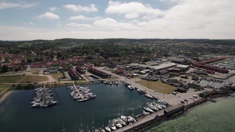 Truck-Shot-of-Marina-in-Idyllic-Surroundings,-Docked-Sail-Boats,-Yachts-and-Motorboats