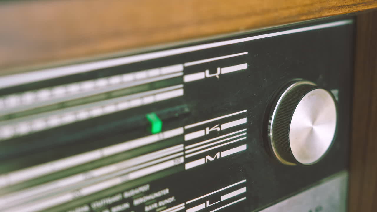 Pull focus close-up revealing radiogram control panel and frequency indicators. Suitable for vintage audio technology, broadcasting equipment and retro electronics visuals