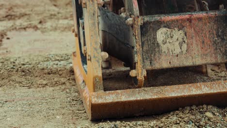 vibratory plate compactor machine compacting gravel close up