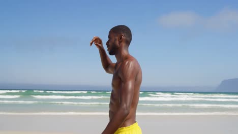 man walking at beach on a sunny day 4k