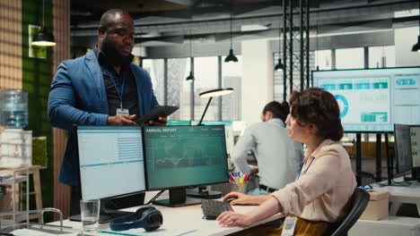 Vertical Video Diverse man and woman saluting each other with fist bump in the business space