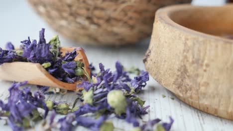 dried purple flowers in wooden bowls