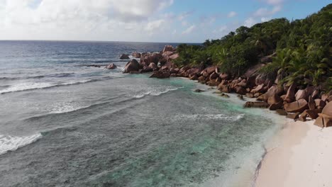 Aerial-view-of-the-white-beaches-and-turquoise-waters-at-Anse-Coco,-Petit-Anse-and-Grand-Anse-on-La-Digue,-an-island-of-the-Seychelles