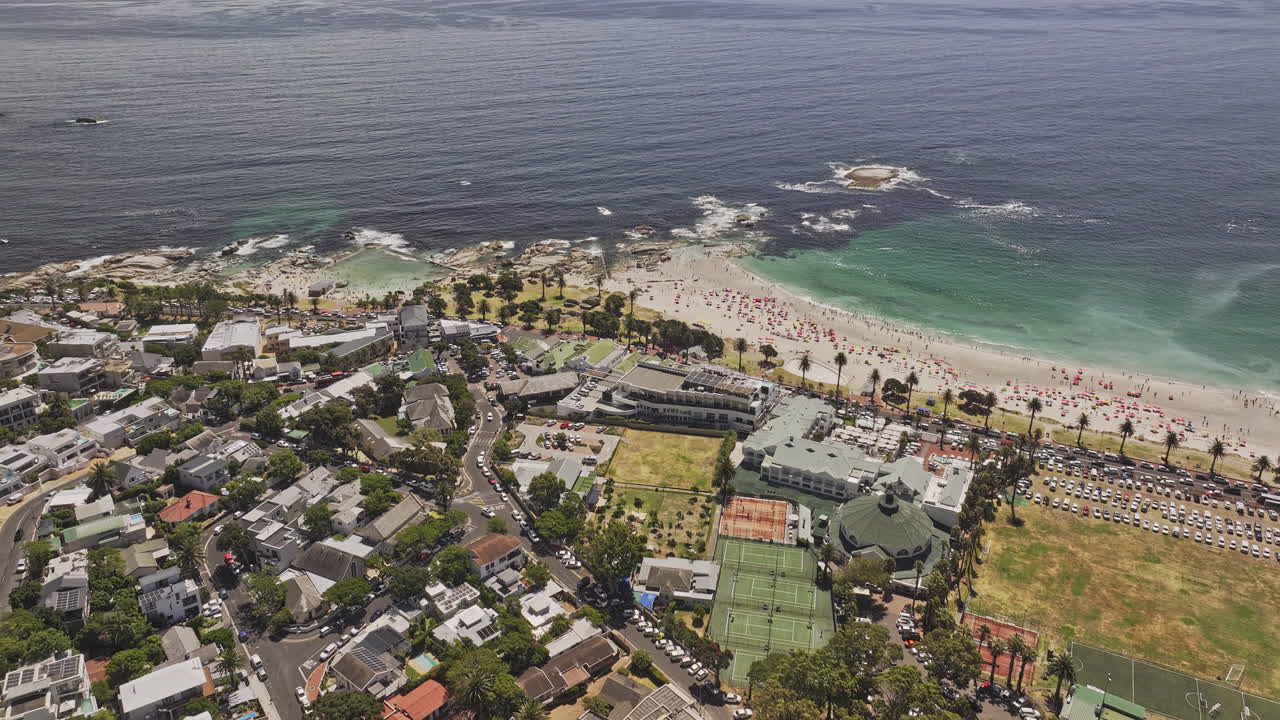 Cape Town South Africa Aerial v80 birds eye view flyover Camps Bay capturing stunning views of the Bakoven residential suburb and the white sandy beach - Shot with Mavic 3 Pro Cine - Jan 11th 2024
