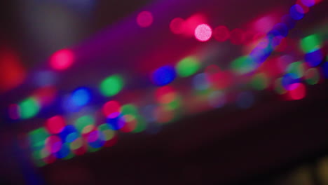 nightlife party lights flashing out of focus in dark club, 4k slow motion