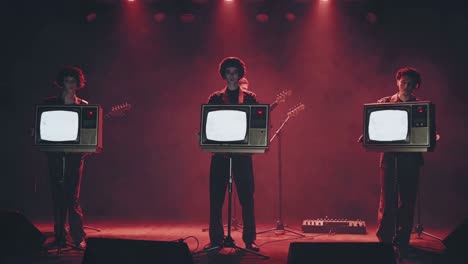 band with tvs as instruments on stage