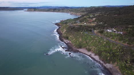 aerial view over manu bay in waikato, new zealand - drone shot