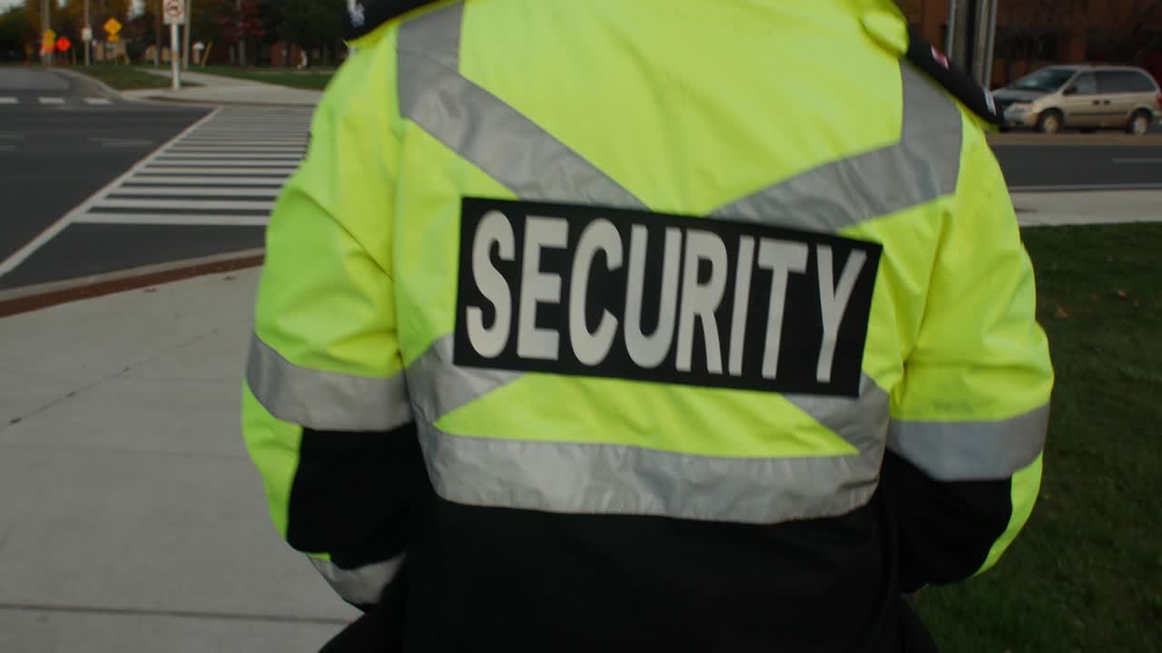 Security guard in uniform patrolling in a commercial area