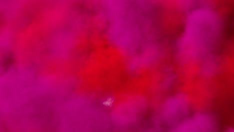 spreading colored smoke, wiping frame concentrically inwards.