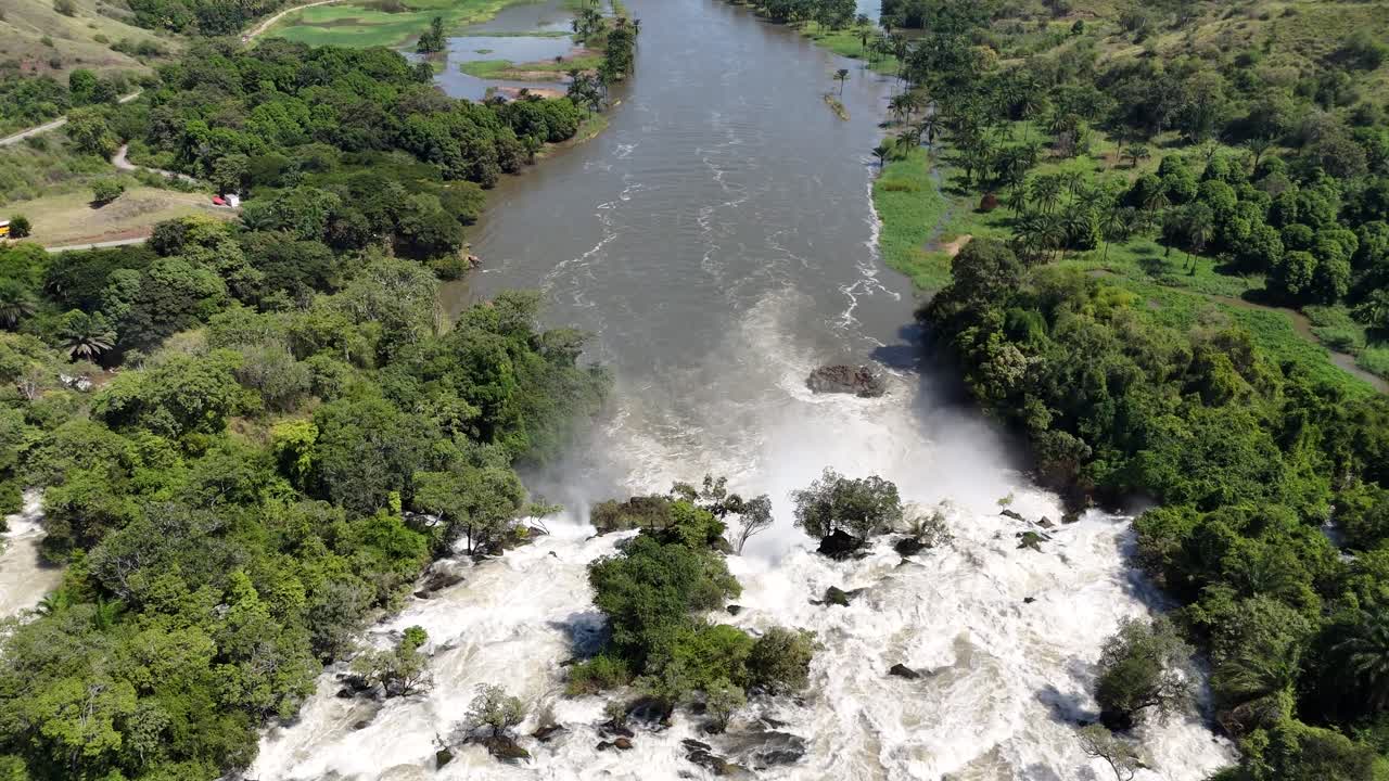 Drone footage showing the Kwanza River flowing toward the Binga Falls in Angola, where the calm surface turns into a powerful cascade through tropical forest