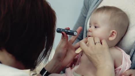 doctor examines the child's throat 1