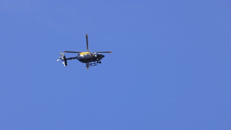 a helicopter flying in clear blue sky