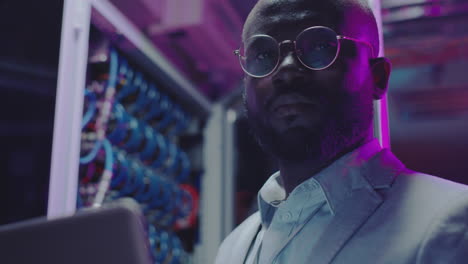 portrait of an it professional in a server room
