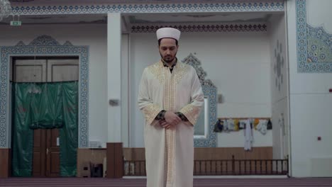 a young man prays in the mosque