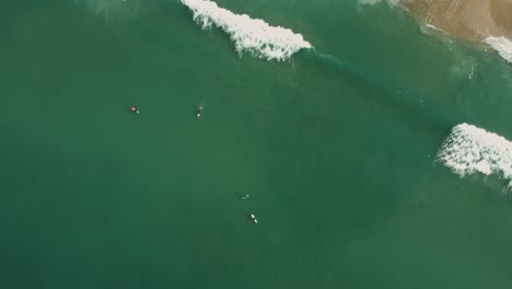 afternoon camera down drone view from little waves and surfing people of redondo beach, california