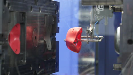 close up of an injection mold machine at work manufacturing plastic mask filter in an industrial factory