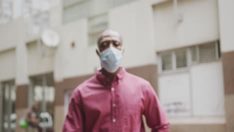 african american man on the go wearing coronavirus covid19 mask