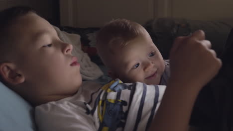 Brother-on-a-tablet-with-younger-baby-sister