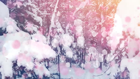 digital composition of pink glowing spots of light against snow landscape with trees