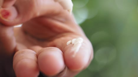 hand squeezing cream from a tube