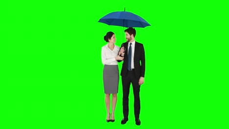 Business-people-standing-under-umbrella
