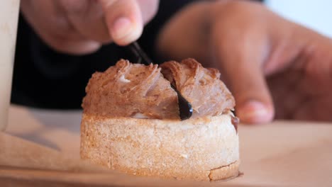 hand placing topping on a small tart