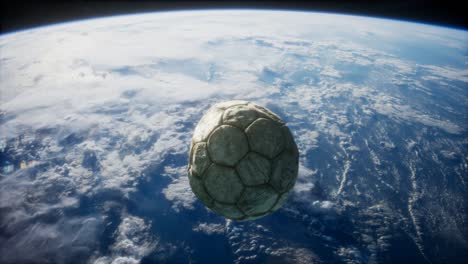 old soccer ball in space on earth orbit