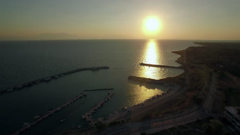 Flying-over-the-sea-and-quay-at-sunrise-Greece