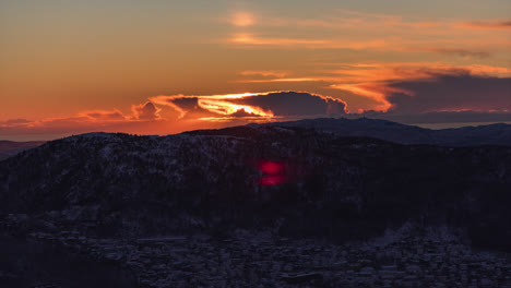 beautiful sunset behind snow capped mountains close to the city